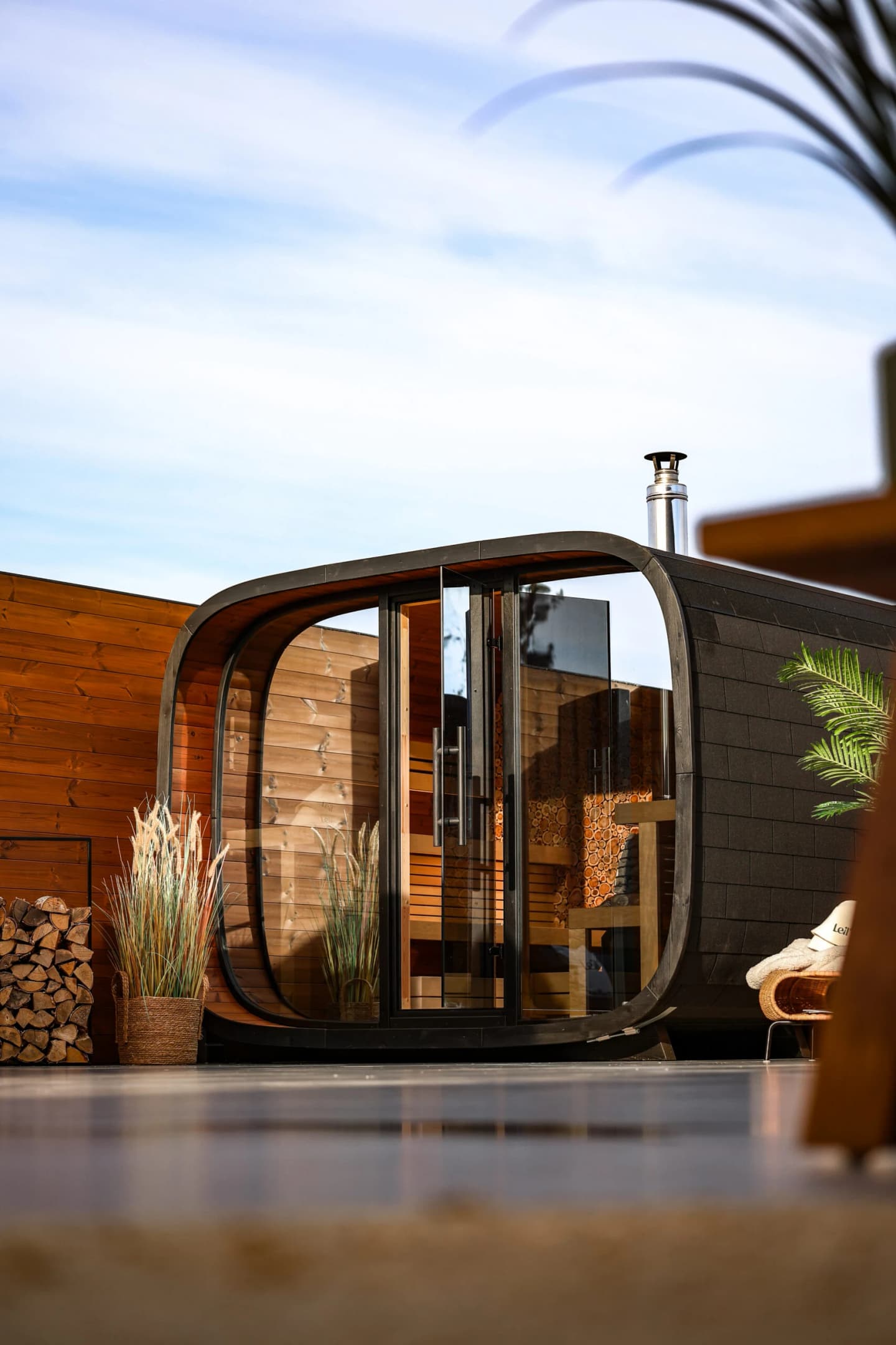 Leil outdoor sauna beside a swimming pool with tropical planting