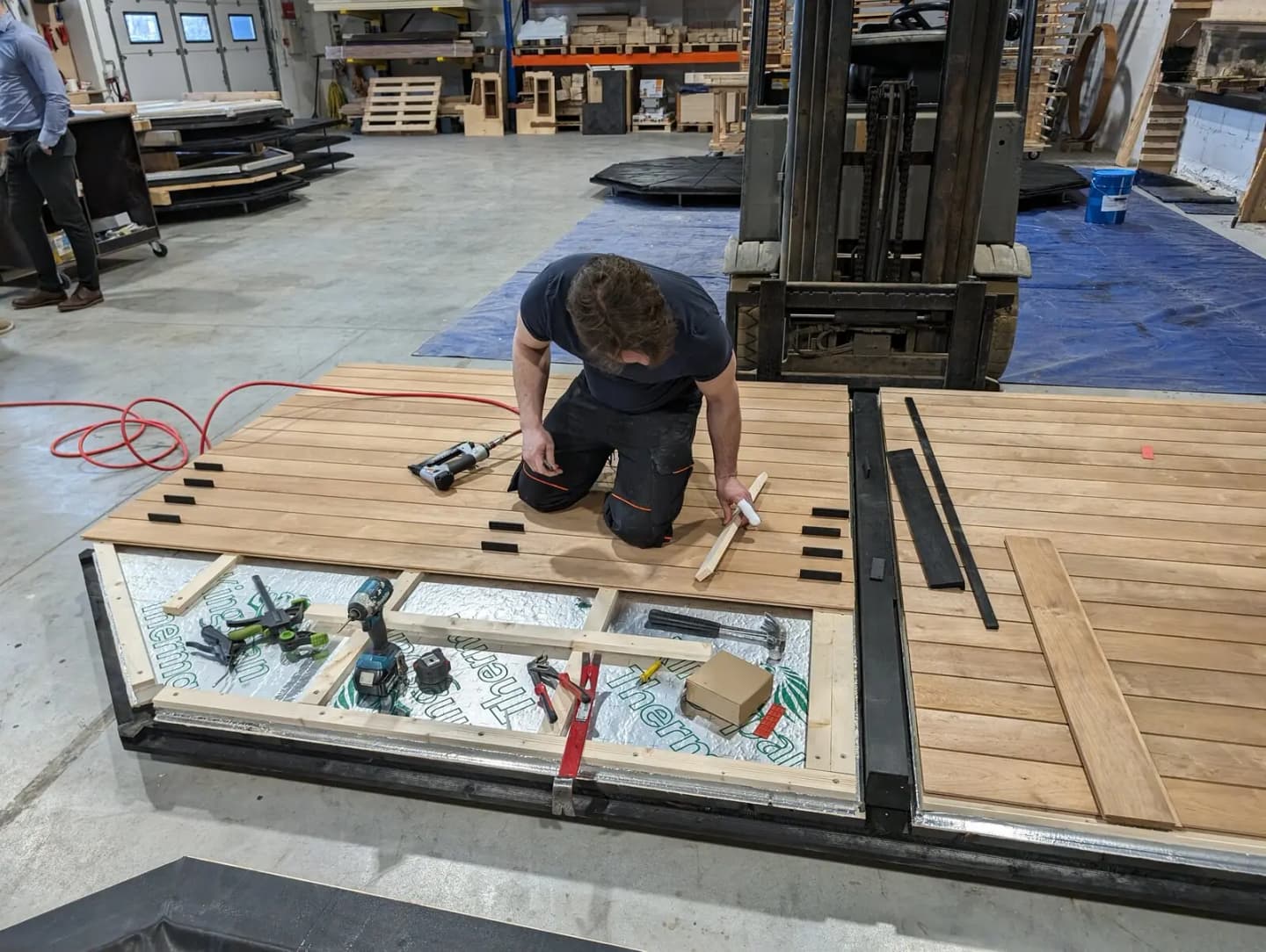A craftsperson building a sauna in a workshop