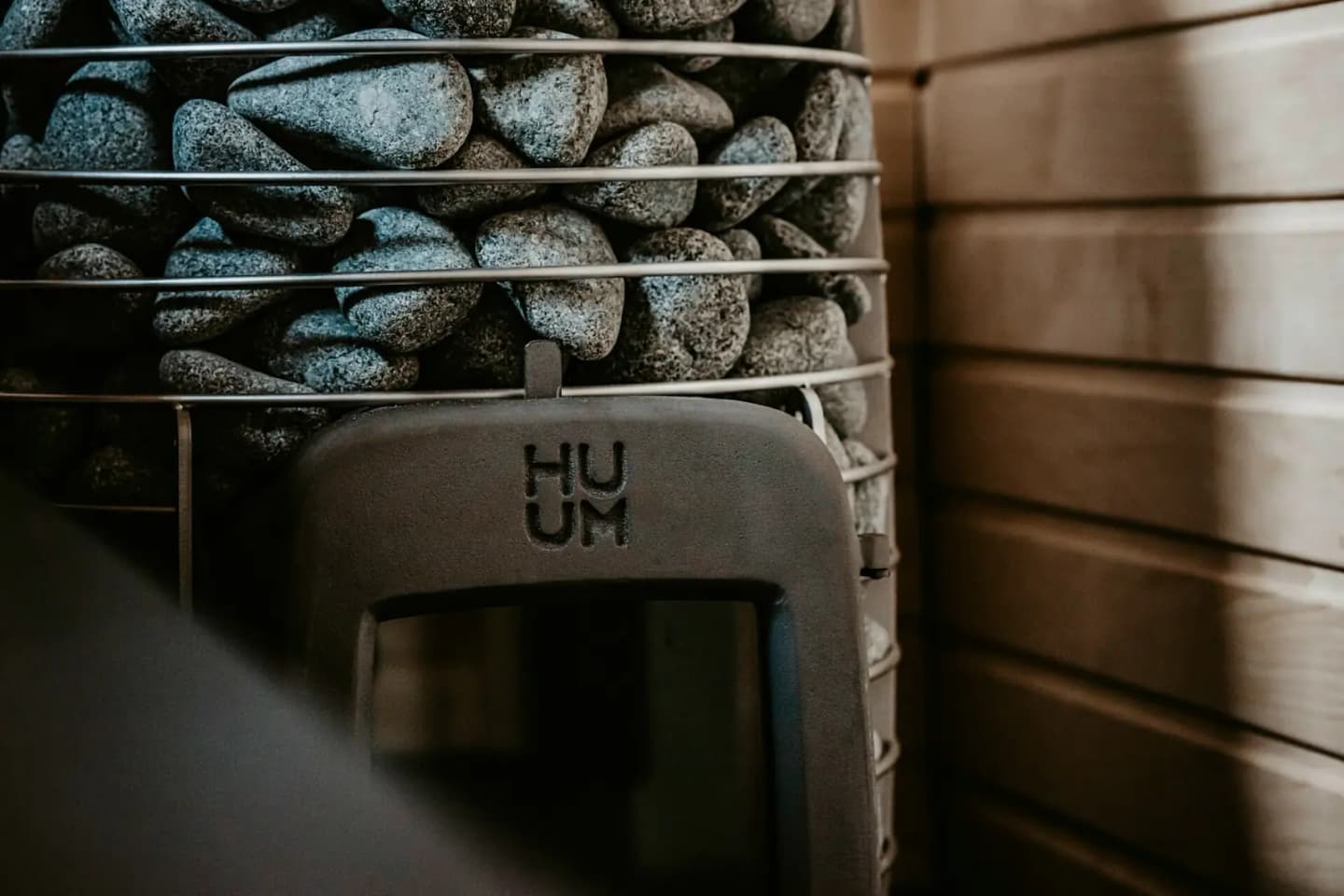 A HUUM stove stacked with sauna stones